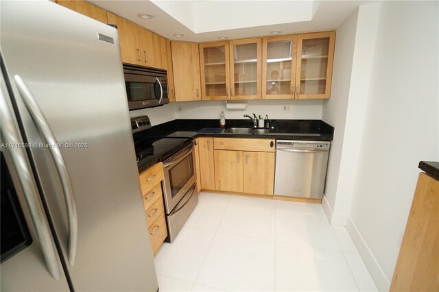 kitchen with light brown cabinets, light tile patterned floors, sink, and appliances with stainless steel finishes