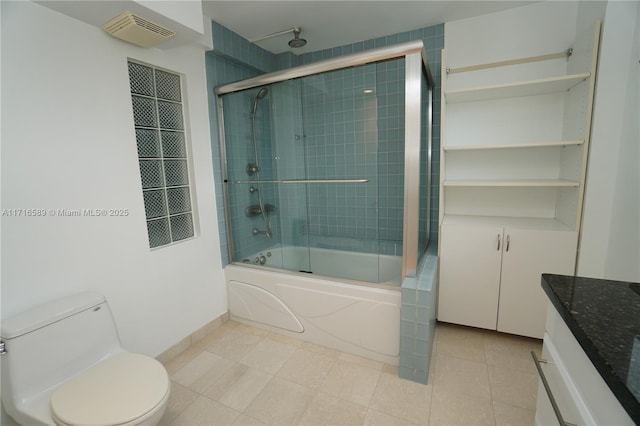 bathroom featuring visible vents, toilet, a combined bath / shower with rainfall shower, vanity, and tile patterned flooring