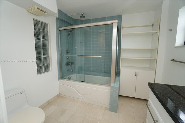 full bathroom featuring toilet, vanity, and combined bath / shower with glass door