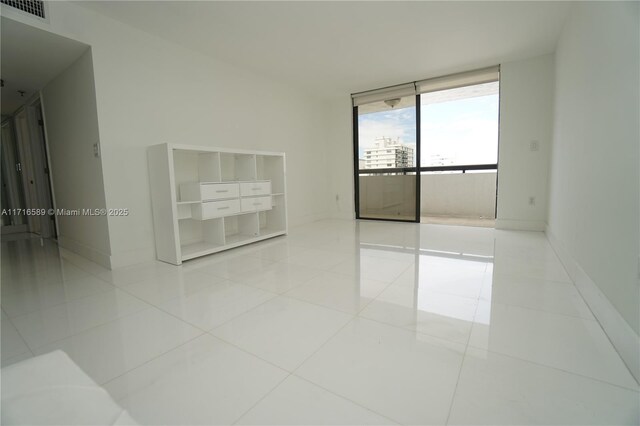 tiled empty room with expansive windows