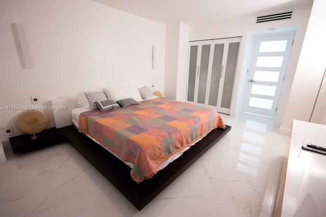 bedroom featuring visible vents and marble finish floor