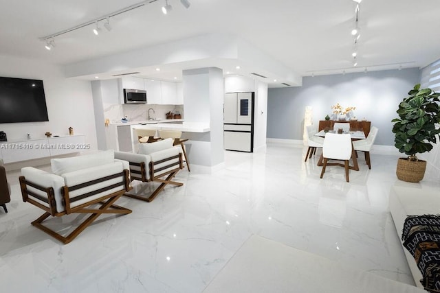 living room with sink and track lighting