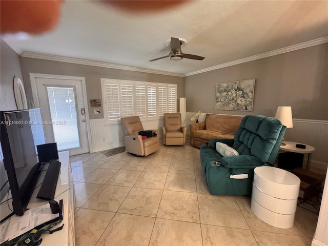 tiled living room with ceiling fan, a healthy amount of sunlight, and ornamental molding