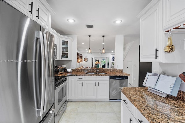 kitchen with white cabinetry, sink, stainless steel appliances, kitchen peninsula, and pendant lighting