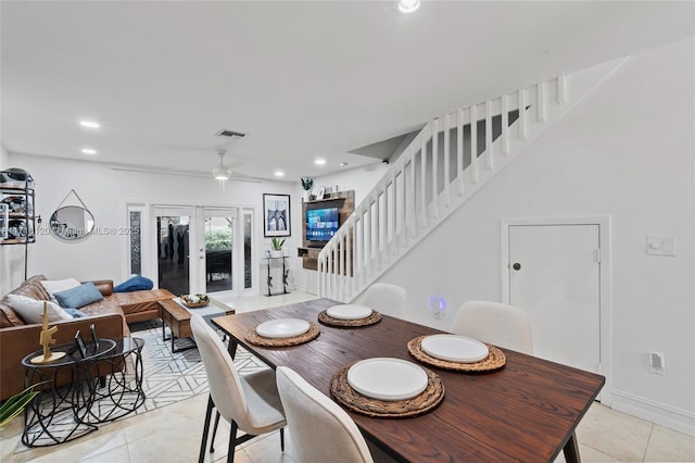 dining space with french doors, light tile patterned floors, and ceiling fan