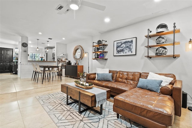 living room featuring ceiling fan and light tile patterned floors