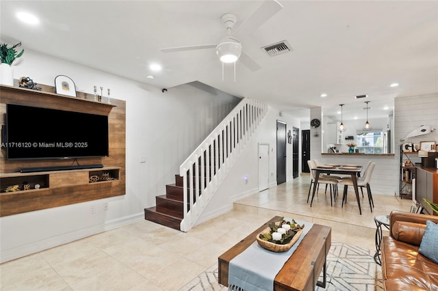 living room with ceiling fan and light tile patterned floors