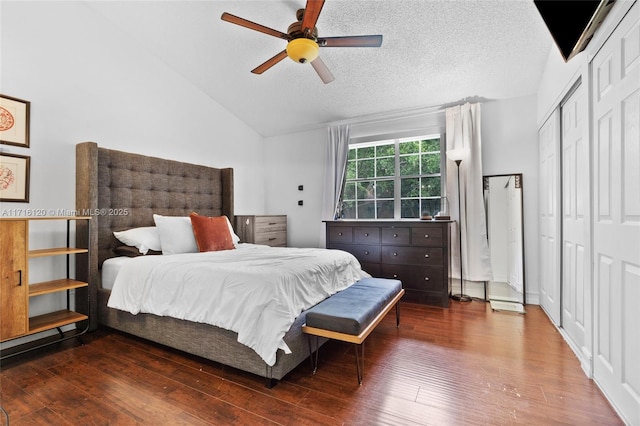 bedroom featuring dark hardwood / wood-style flooring, a textured ceiling, vaulted ceiling, ceiling fan, and a closet