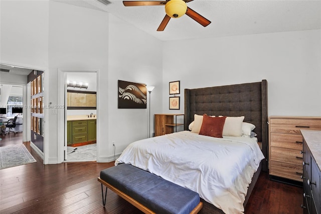 bedroom featuring connected bathroom, ceiling fan, dark wood-type flooring, and sink