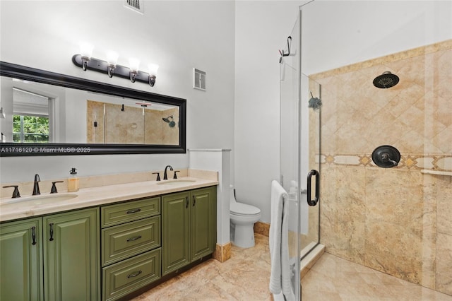 bathroom featuring tile patterned floors, vanity, toilet, and an enclosed shower