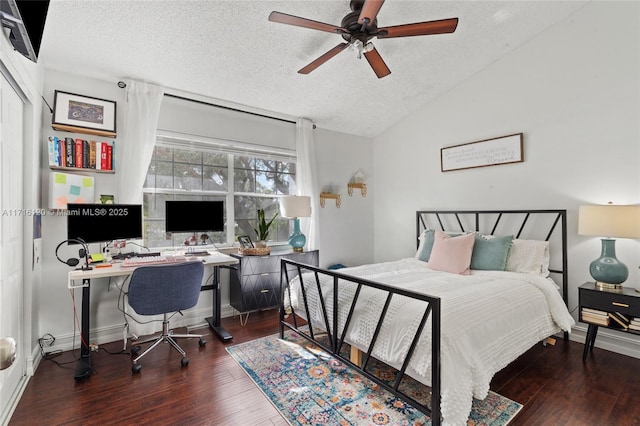 bedroom featuring dark hardwood / wood-style flooring, a textured ceiling, ceiling fan, and lofted ceiling