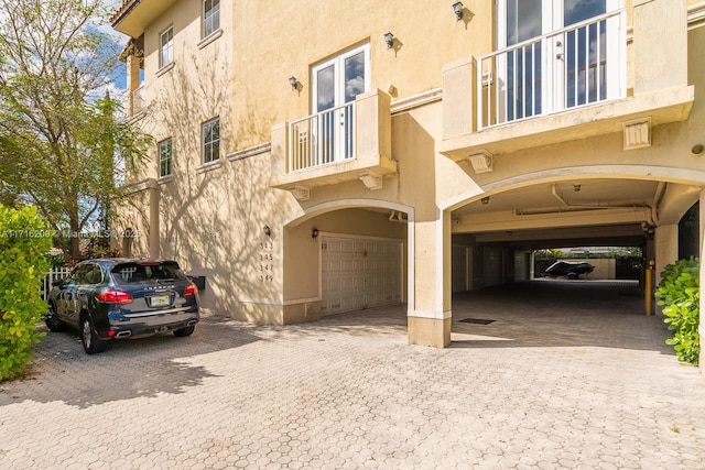 exterior space with a balcony and a garage