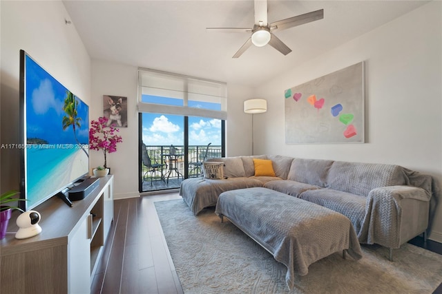 living room featuring ceiling fan, expansive windows, and dark hardwood / wood-style flooring