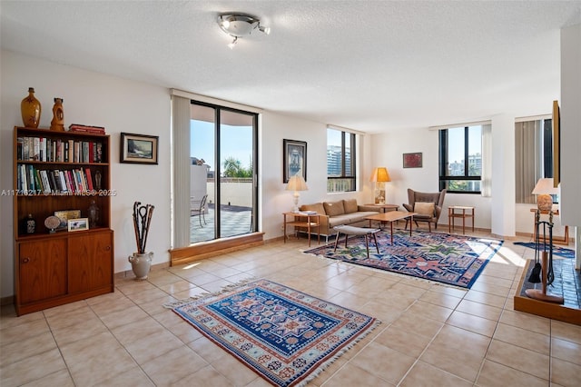 living room featuring light tile patterned flooring and a textured ceiling