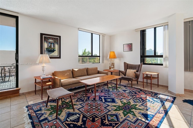 living room featuring light tile patterned floors and a textured ceiling