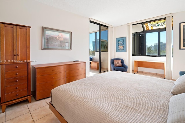 bedroom with light tile patterned flooring, access to exterior, and multiple windows