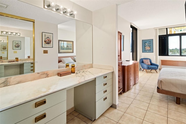 bathroom with tile patterned floors and a textured ceiling