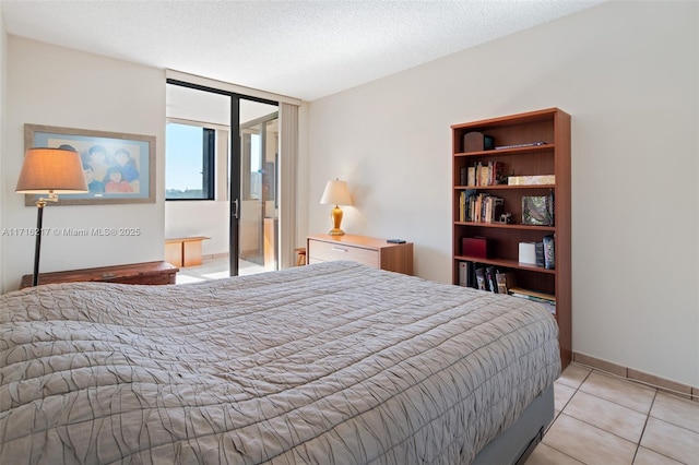 tiled bedroom with a textured ceiling