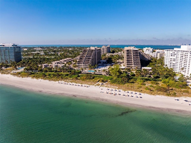 birds eye view of property featuring a beach view and a water view