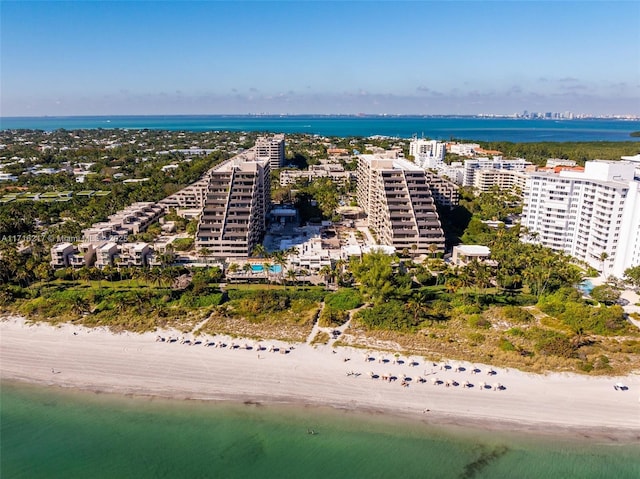 birds eye view of property with a water view and a view of the beach