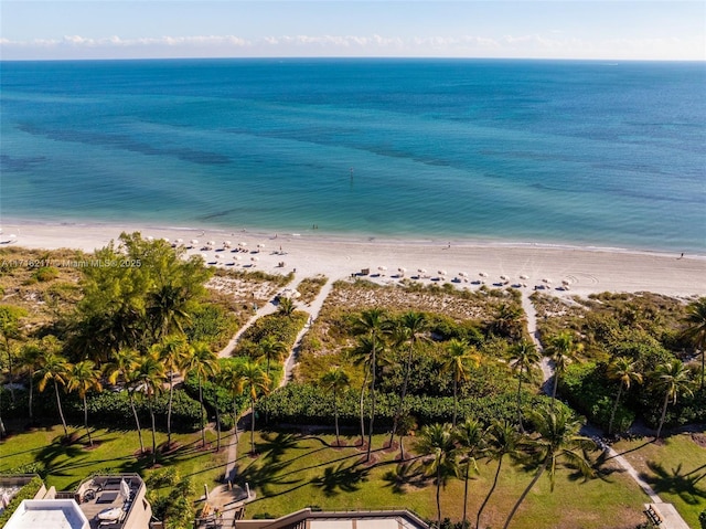 birds eye view of property featuring a beach view and a water view