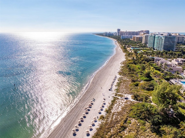 bird's eye view featuring a water view and a beach view