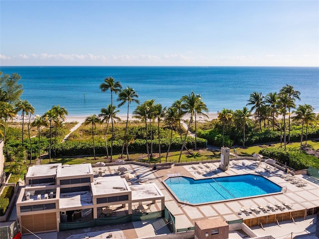 view of swimming pool featuring a water view