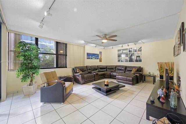 tiled living room featuring ceiling fan, a textured ceiling, and track lighting