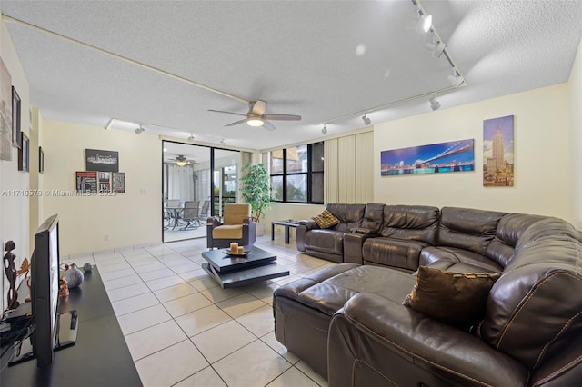 living room featuring ceiling fan, light tile patterned flooring, a textured ceiling, and track lighting