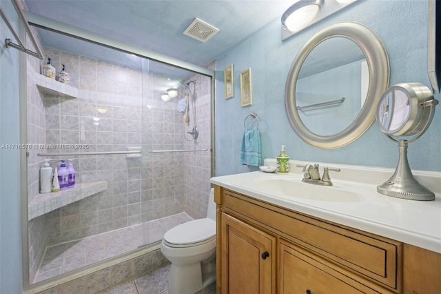 bathroom with toilet, an enclosed shower, and vanity