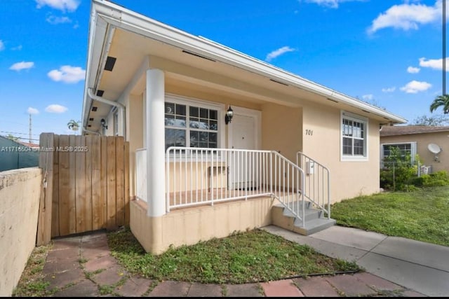 exterior space featuring a porch and a front yard