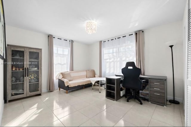 office space with a chandelier and light tile patterned floors