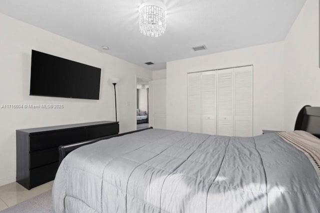 bedroom featuring a closet and a notable chandelier