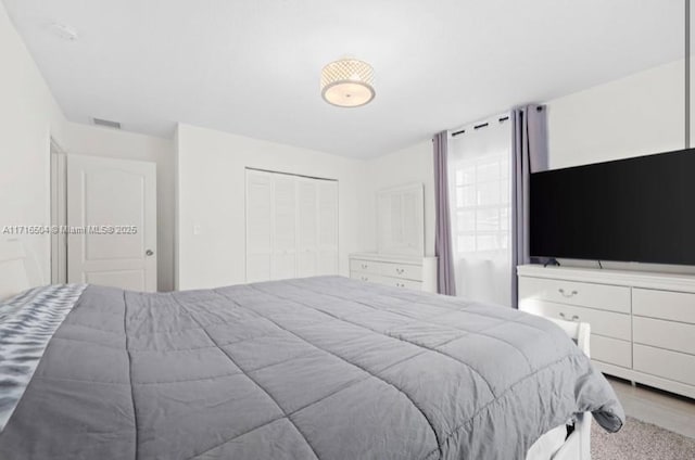 carpeted bedroom with a closet