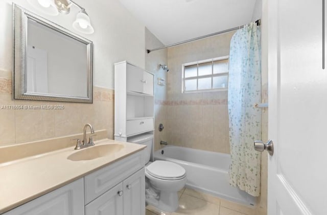 full bathroom featuring vanity, tile patterned floors, toilet, shower / bathtub combination with curtain, and tile walls