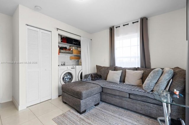 living room featuring light tile patterned flooring and separate washer and dryer