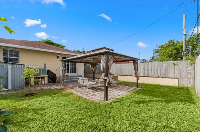 rear view of house featuring a gazebo, a storage shed, a patio, and a lawn