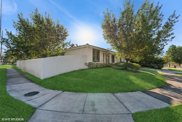 view of property exterior featuring a lawn