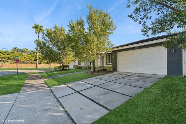 view of front facade with a garage and a front lawn