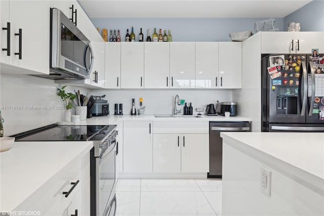 kitchen with white cabinets, sink, and stainless steel appliances