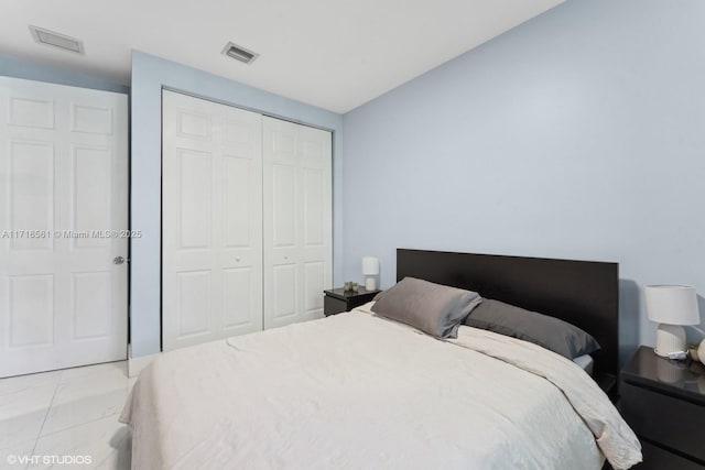 bedroom featuring light tile patterned floors and a closet