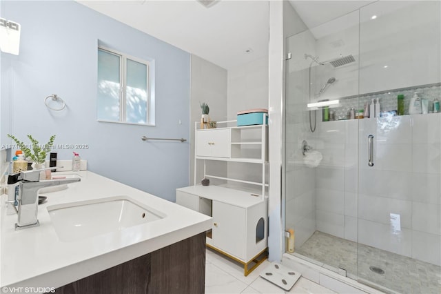 bathroom with tile patterned flooring, vanity, and a shower with door