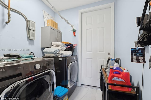 washroom with washer and dryer