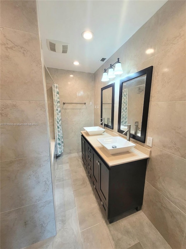 bathroom with vanity and tile walls