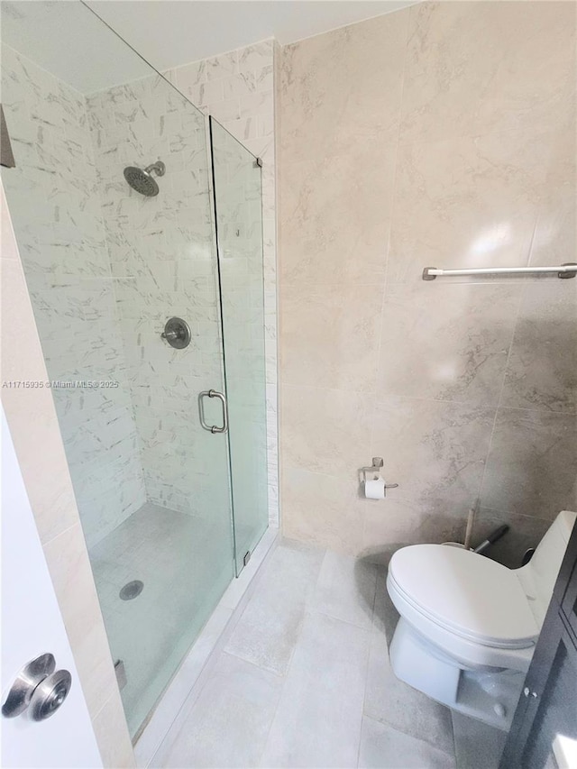 bathroom featuring tile patterned flooring, an enclosed shower, tile walls, and toilet