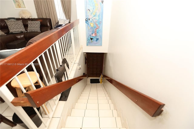 staircase featuring tile patterned floors