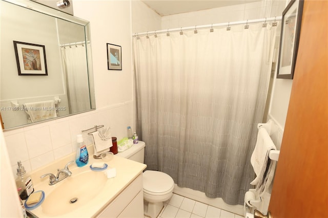 bathroom with decorative backsplash, vanity, tile walls, tile patterned flooring, and toilet