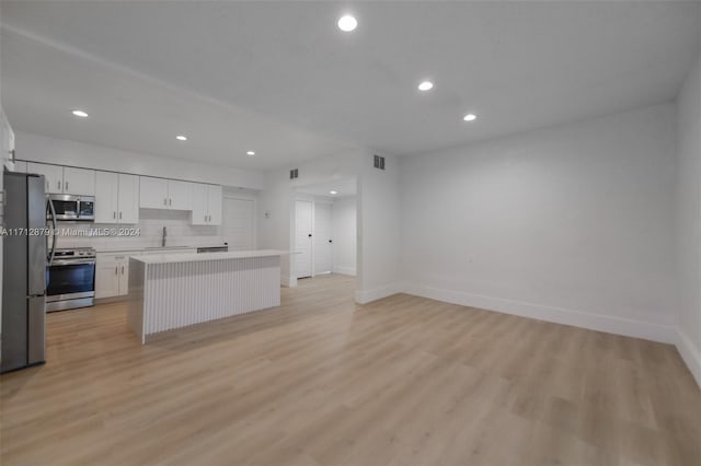 kitchen with white cabinets, a center island, light hardwood / wood-style floors, and stainless steel appliances