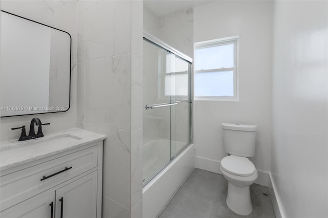 full bathroom featuring toilet, vanity, and combined bath / shower with glass door