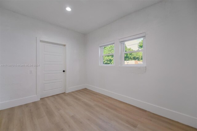 empty room with light hardwood / wood-style flooring